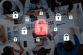 Team Collaboration Around Laptop with Cybersecurity Theme Featuring Padlock Icons and Data Visualization in an Office Royalty Free Stock Photo