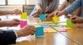 Team collaboration and brainstorming session with colorful sticky notes on a table isolated on white background Royalty Free Stock Photo