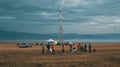 Team Collaboration at Remote Site with Communication Tower and Equipment Royalty Free Stock Photo