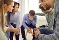 Team of colleagues, friends, or people in group therapy trying to comfort a sad man Royalty Free Stock Photo