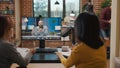 Team of colleagues meeting with man on online video call Royalty Free Stock Photo