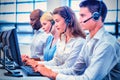 Team of colleagues working on computer with headset Royalty Free Stock Photo