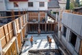 Team of the construction workers works on foundation of contemporary house. Royalty Free Stock Photo