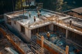 Team of the construction workers works on foundation of contemporary house. Royalty Free Stock Photo