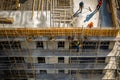 Team of the construction workers works on foundation of contemporary house. Royalty Free Stock Photo