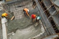 Team of the construction workers works on foundation of contemporary house. Royalty Free Stock Photo