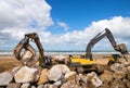 crane or excavator equipped with a grapple handling large rocks Royalty Free Stock Photo
