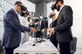 Team of creative multiracial colleagues, designers, architect in formal wear, standing around the table and using vr Royalty Free Stock Photo