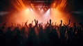 Team. A crowd of people in silhouette raises their hands on the dancefloor on neon light background. Night life, club, music, Royalty Free Stock Photo