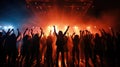 Team. A crowd of people in silhouette raises their hands on the dancefloor on neon light background. Night life, club, music, Royalty Free Stock Photo