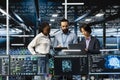 Team of data center coworkers in office running AI forecasting simulations Royalty Free Stock Photo