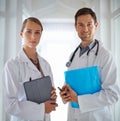 Team diagnosis. Portrait of two young doctors standing in a hospital corridor. Royalty Free Stock Photo