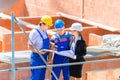 Team discussing construction or building site plans Royalty Free Stock Photo