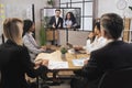 Team of diverse four multiethnic businesspeople having video meeting in boardroom