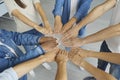 Team of diverse men and women joining hands to show concept of union and teamwork Royalty Free Stock Photo