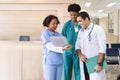 Team of diversity doctor and nurse is discussing and brainstorming on patient medical record using laptop computer after diagnosis Royalty Free Stock Photo