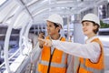 Team of diversity engineer is using walkie talkie while inspecting the construction project for modern architecture and real Royalty Free Stock Photo