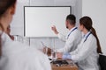 Team of doctors looking at projection screen Royalty Free Stock Photo