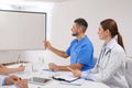 Team of doctors looking at projection screen Royalty Free Stock Photo