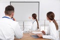 Team of doctors looking at projection screen Royalty Free Stock Photo