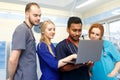 Multiracial team of young doctors working on laptop computer in medical office. Royalty Free Stock Photo