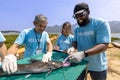 Team of ecologist volunteer pulling non biodegradable micro plastic from the endanger species fish due to the irresponsible waste