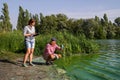 Team of ecologists take samples of green algae on bank of polluted river Royalty Free Stock Photo