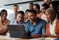 Team effort for the win. a group of young businesspeople using a laptop at a conference in a modern office. Royalty Free Stock Photo