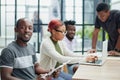 team of employees in a modern office at work. young african american man looking at camera Royalty Free Stock Photo