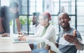 team of employees in a modern office at work. young african american man looking at camera Royalty Free Stock Photo