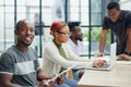 team of employees in a modern office at work. young african american man looking at camera Royalty Free Stock Photo