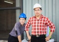 Team of Engineer planning group project partners meeting at building site, Man in hard hat standing and looking at camera at Royalty Free Stock Photo