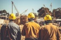 Team of engineers and architects working on a construction site. Selective focus, rear view of Construction workers at the