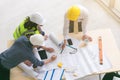 Team of engineers and architects working, planing, measuring layout of building blueprints in construction site. top view Royalty Free Stock Photo