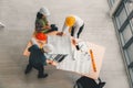 Team of engineers and architects working, planning, measuring layout of building blueprints in construction site. top view Royalty Free Stock Photo