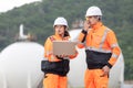 Team of Engineers Conducting Operations at the Oil Storage Field Industrial Site, Industrial Workers Communicating and Using Royalty Free Stock Photo