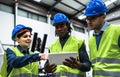 Team of engineers working in robotic factory while analyzing the project on the tablet Royalty Free Stock Photo