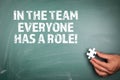 In the team everyone has a role. Teamwork, business, achievements and development concept. Green chalk board Royalty Free Stock Photo