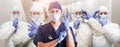 Team of Female and Male Doctors or Nurses Wearing Personal Protective Equipment In Hospital Hallway