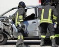 team of firefighters opens the damaged car