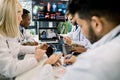 Team of five diverse multiethnic doctors having video conference meeting in hospital, chatting with their two young Royalty Free Stock Photo