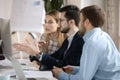 Team of focused business people looking at monitor