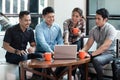 Team of four dedicated employees working together at an innovative project Royalty Free Stock Photo