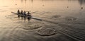 Team of four rowers practice in racing canoe