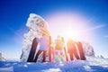 Team friends snowboarders, skier stands with ski and snowboard in hands freeride background blue sky with sunlight