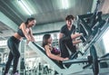 Team of friends working out leg press in fitness gym together, cheering each other Royalty Free Stock Photo