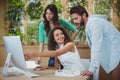 Team of graphic designers discussing over computer at desk Royalty Free Stock Photo