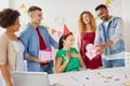 Team greeting colleague at office birthday party Royalty Free Stock Photo