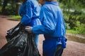 Team group of young people, girls and boys volunteering and participate in community work cleaning day, activists collecting waste