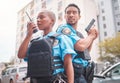 Team, gun and police in the city for crime, talking into equipment and ready for action. Security, law and a black woman Royalty Free Stock Photo